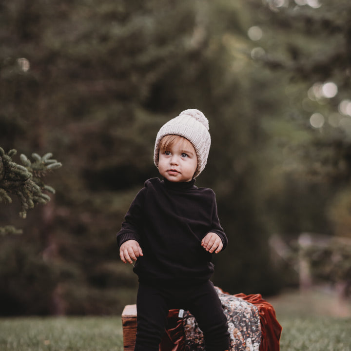 Child wearing Organic Pique Mock-Neck Sweater & Pant Set in Black.