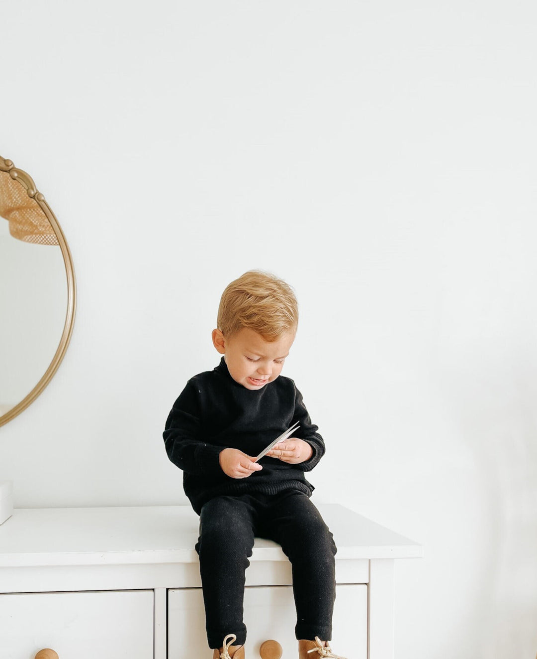 Child wearing Organic Pique Mock-Neck Sweater & Pant Set in Black.