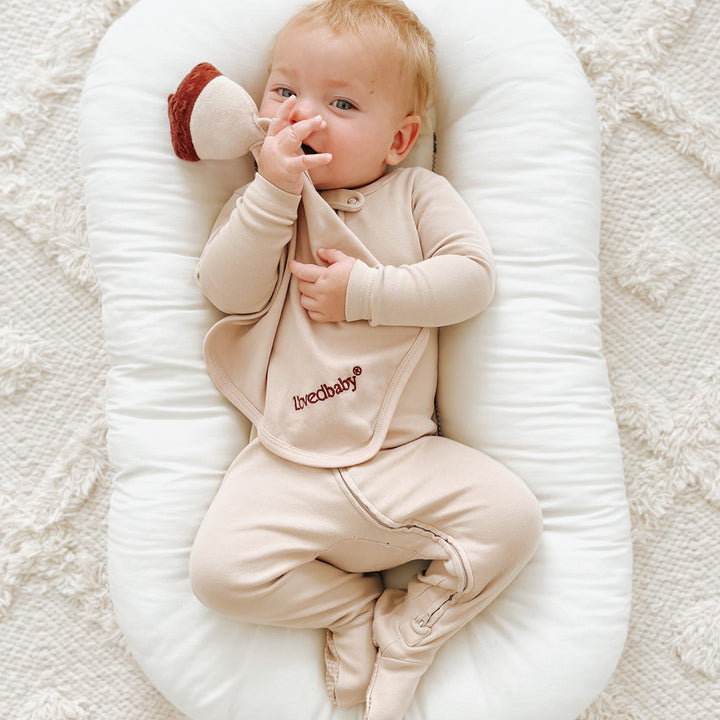 Child wearing Organic Cotton Lovey in Oatmeal.