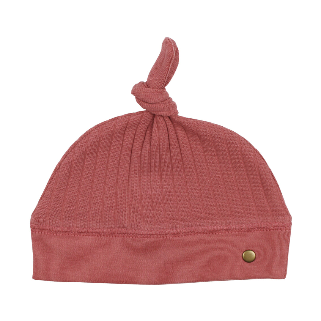 Ribbed Top-Knot Hat in Sienna, a dark pink color.
