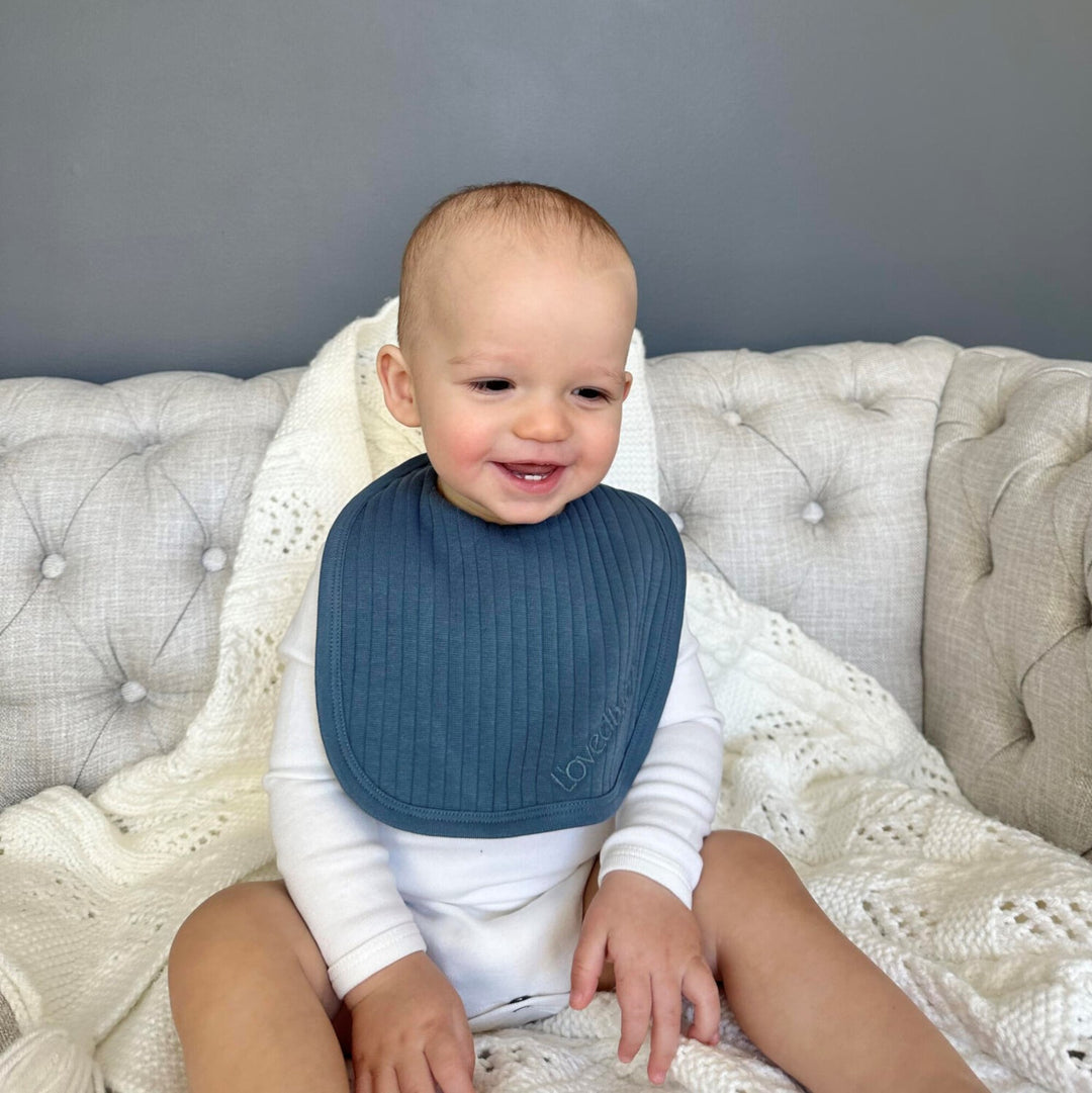Child wearing Ribbed Square Bib in Dolphin.