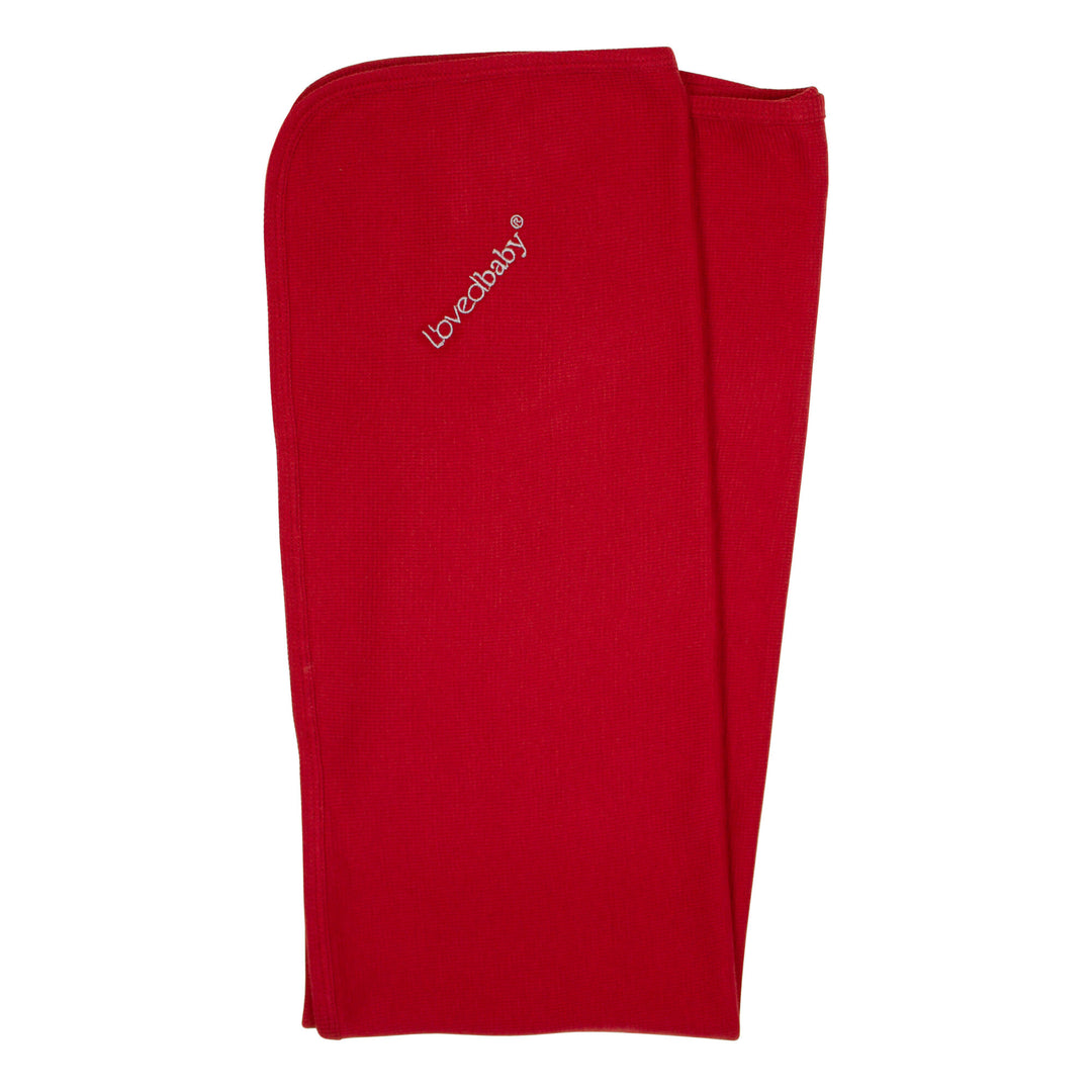 Organic Thermal Swaddling Blanket in Cherry, a bright red color.