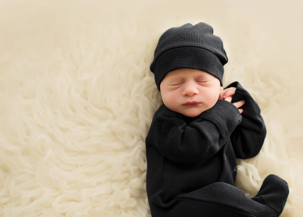 Child wearing Organic Thermal Knotted Cap in Black.