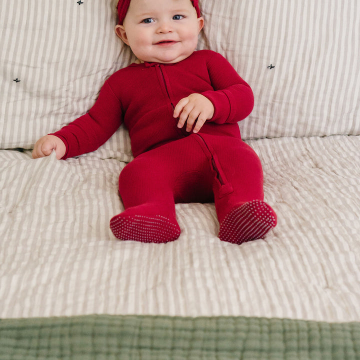 Child wearing Thermal 2-Way Zipper Footie in Crimson.