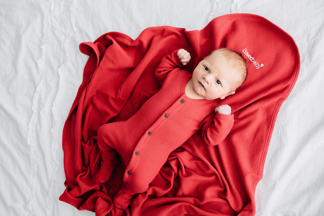 Child wearing Organic Thermal Footie in Cherry.