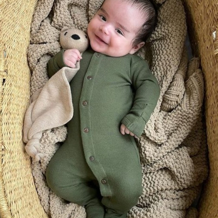 Child wearing Organic Thermal Footie in Forest.