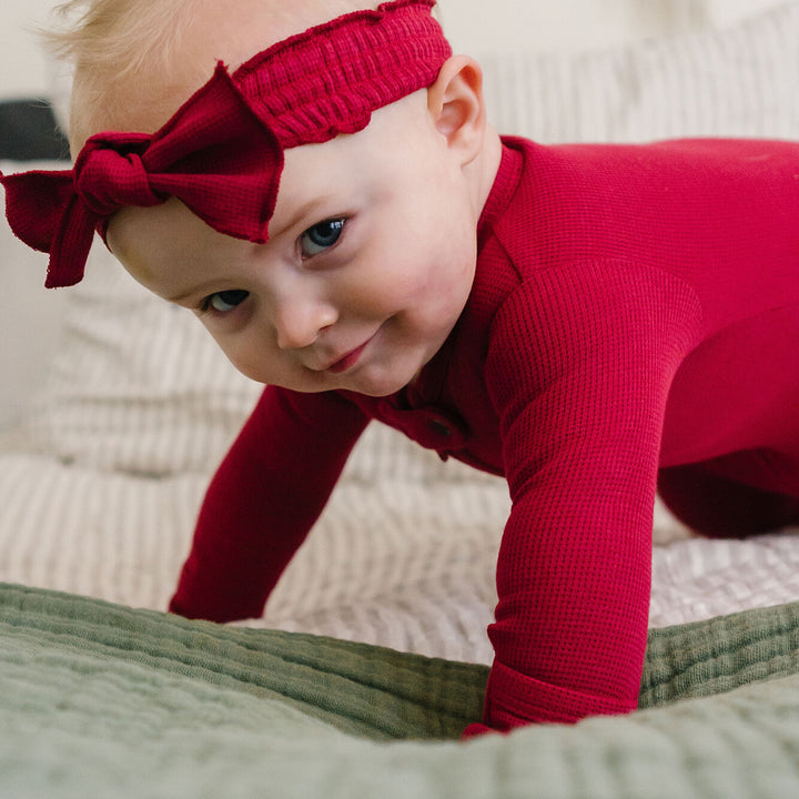 Child wearing Thermal Smocked Headband in Crimson.