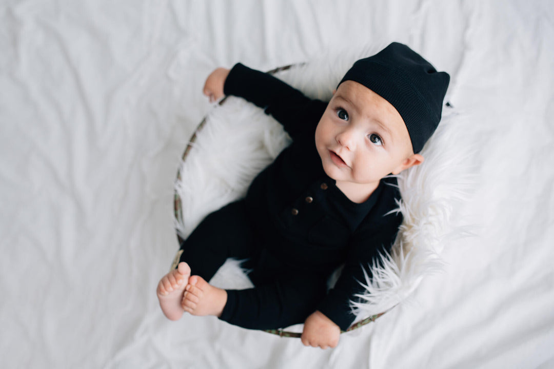 Child wearing Organic Thermal Baby Lounge Set in Black.
