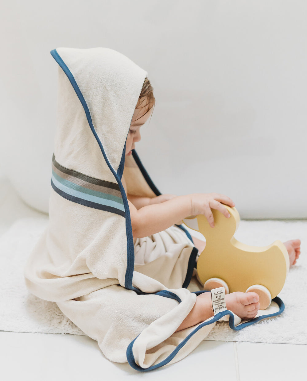 Child wearing Organic Terry Cloth Hooded Towel in Blues.