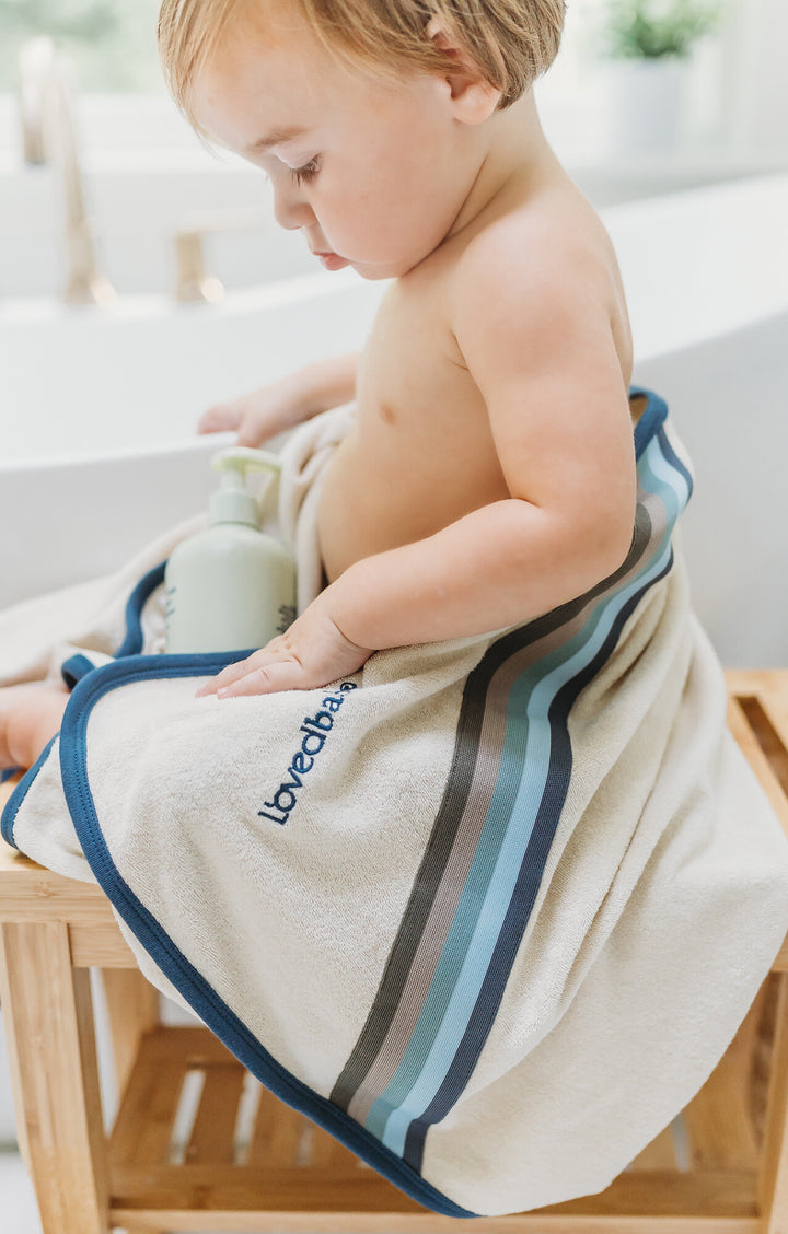 Child wearing Organic Terry Cloth Hooded Towel in Blues.