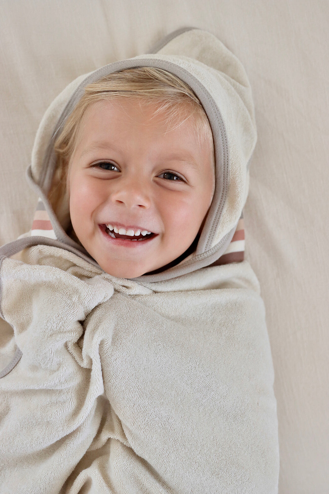 Child wearing Organic Terry Cloth Hooded Towel in Neutrals.