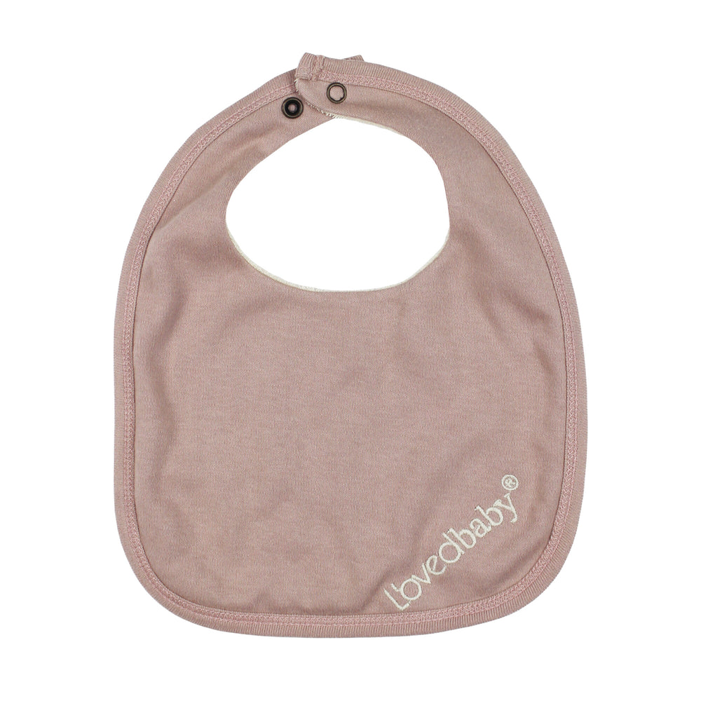 Back view of Organic Terry Cloth Reversible Bib in Pinks, a trio of light pink, salmon pink, and medium pink.