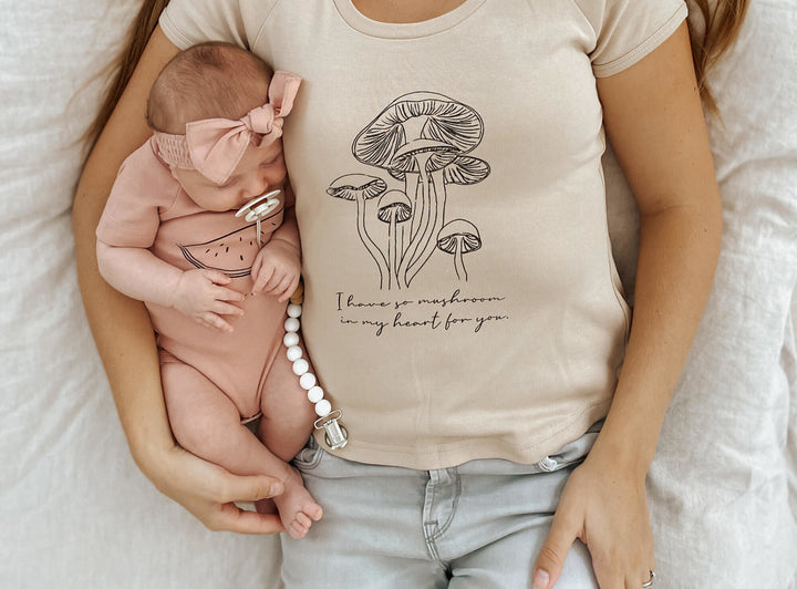 Child wearing Women's Raglan T-Shirt in Oatmeal Mushrooms.