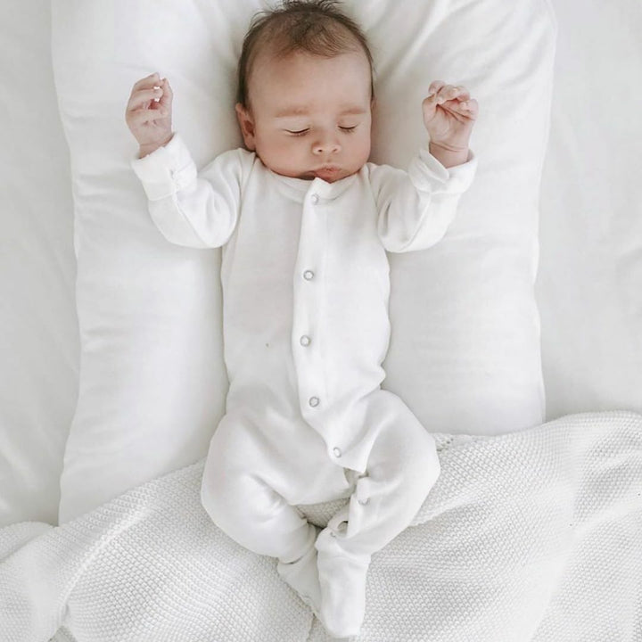 Child wearing Organic Snap Footie in White. Credit: 