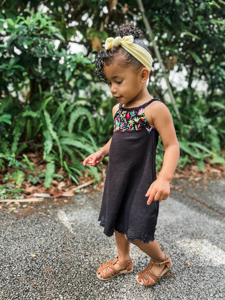 Child wearing Kids' Embroidered Twirl Dress w/Pockets in Black Floral.