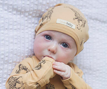 Child wearing Organic Cute Cap in Honey Giraffe.