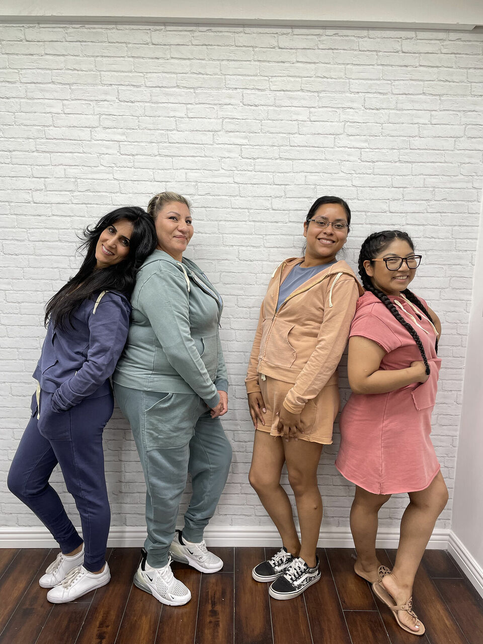 4 women wearing 4 different styles and colors of French Terry sets.