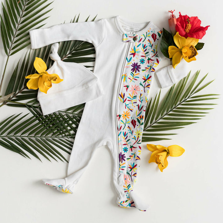 Child wearing Embroidered Zipper Footie in White Floral.