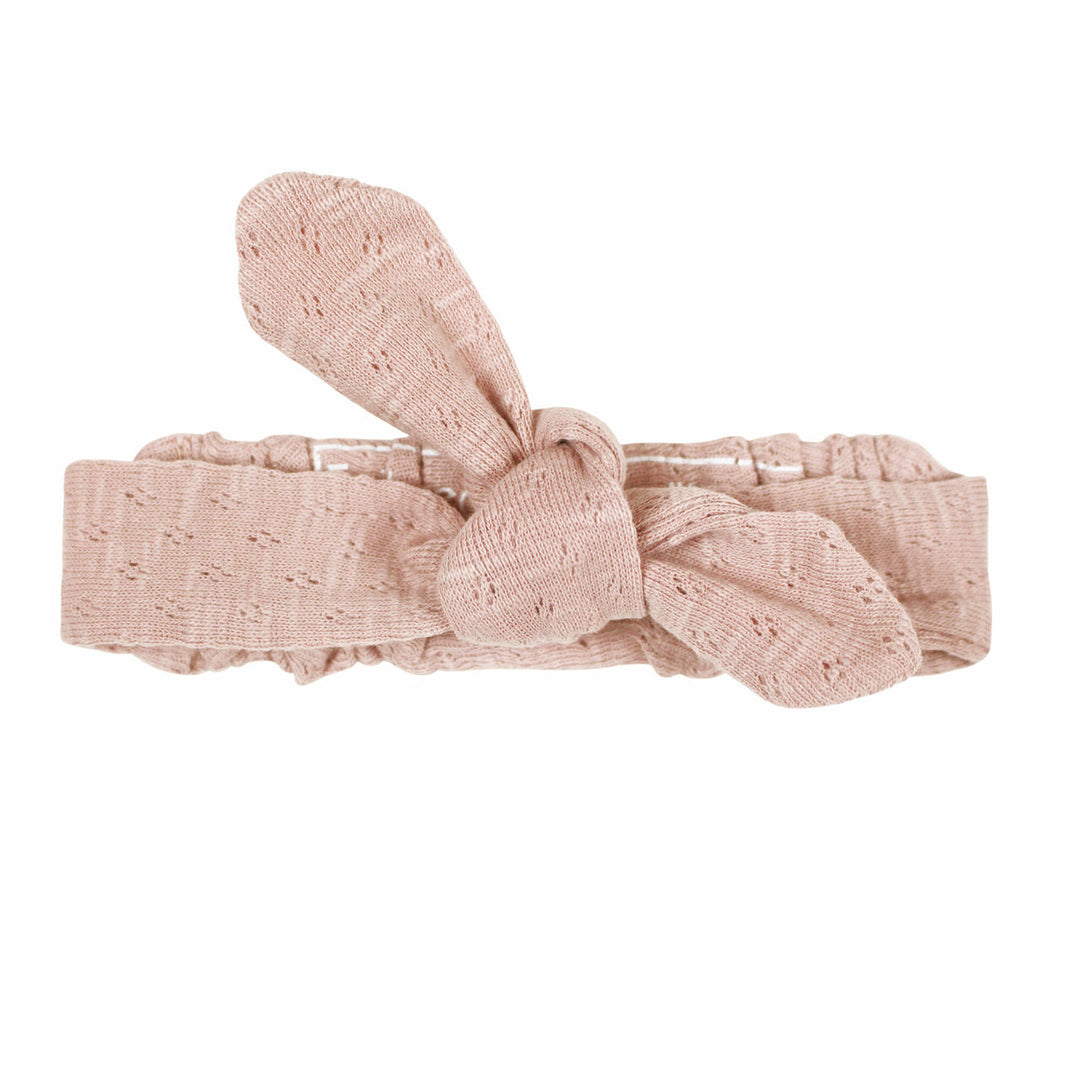 Pointelle Tie Headband in Mermaid, a shimmery light pink color.