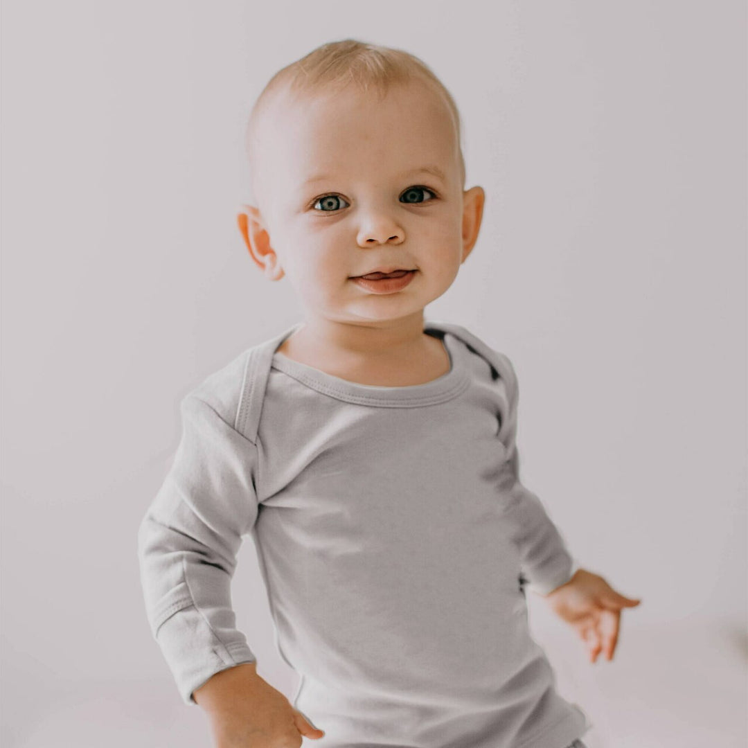 Child wearing Organic L/Sleeve Shirt in Light Gray.