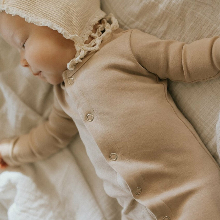 Child wearing Organic Snap Footie in Oatmeal. Credit: @montanaleephotography