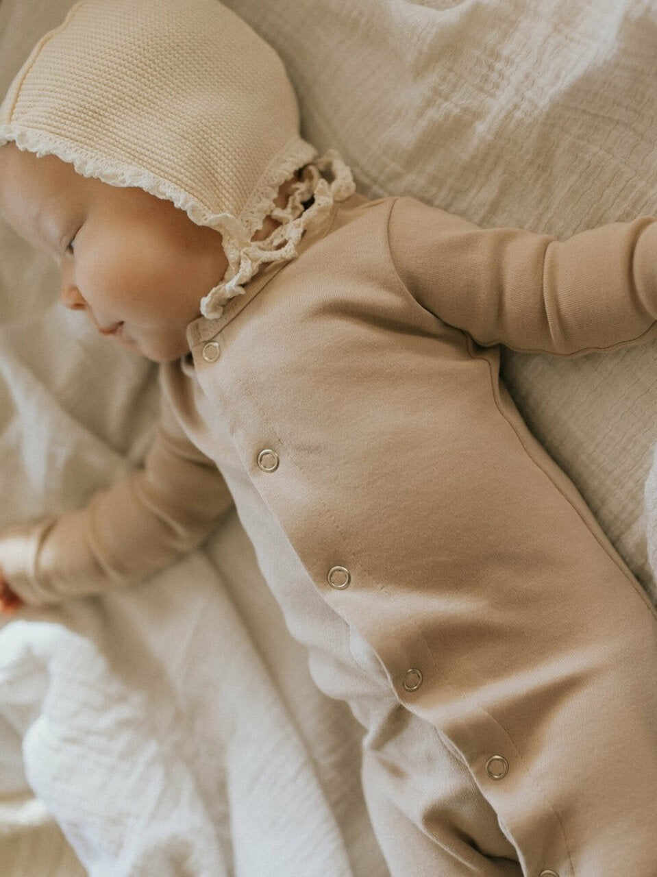 Child wearing Organic Snap Footie in Oatmeal. Credit: @montanaleephotography