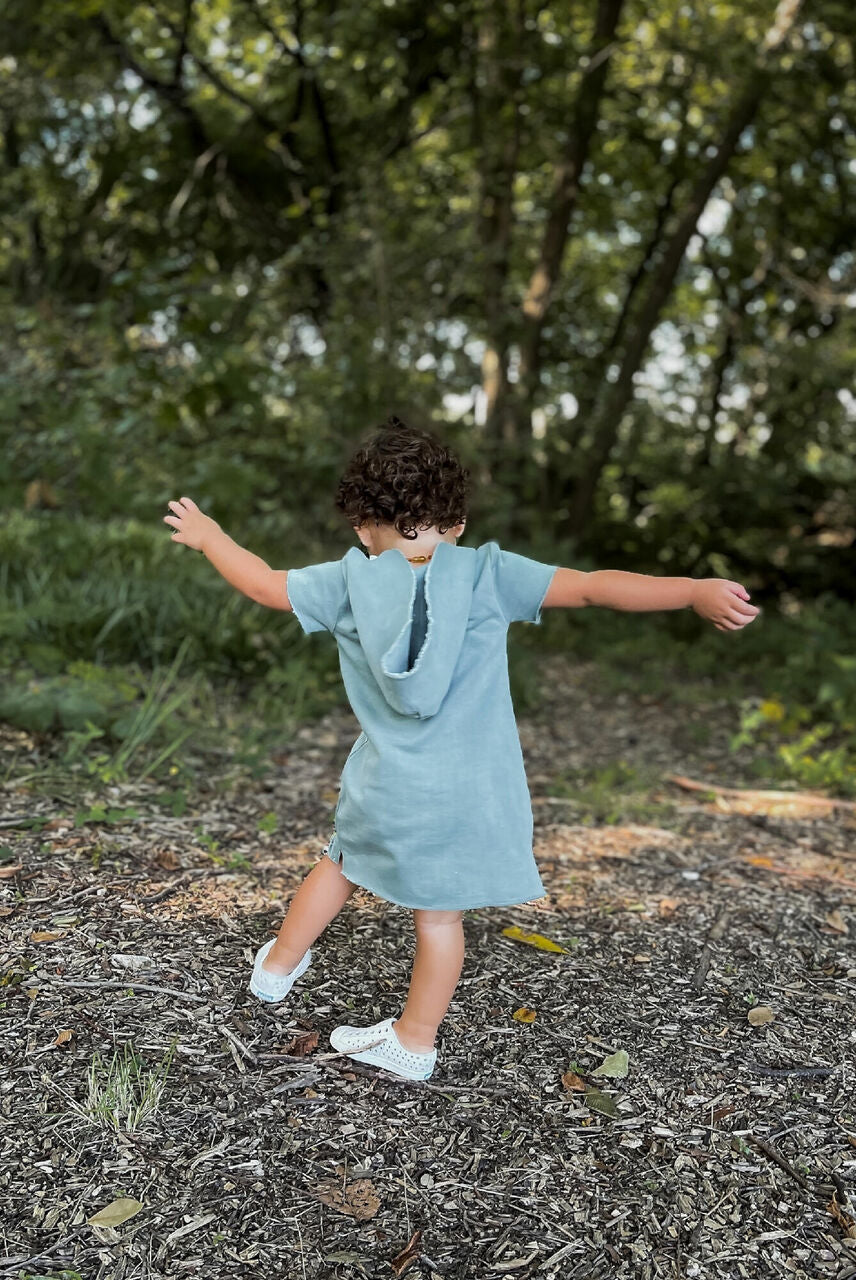 Child wearing Kids' French Terry Hoodie Dress in Jade.