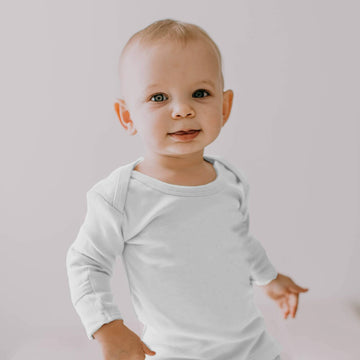 Child wearing Organic L/Sleeve Shirt in White.
