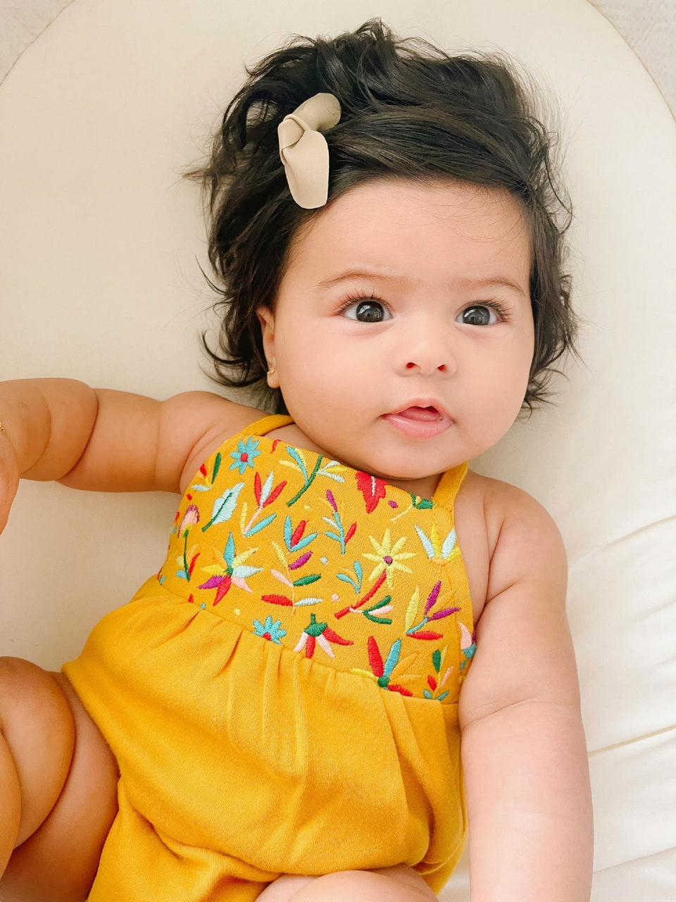 Child wearing Embroidered Criss-Cross Bodysuit in Tangerine Floral.