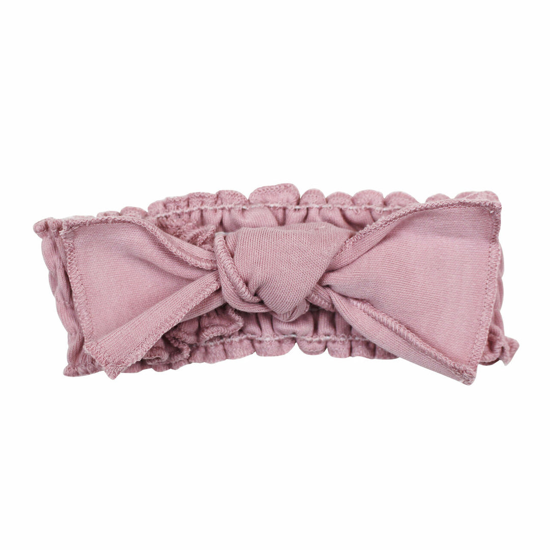 Organic Smocked Tie Headband in Blossom, a soft pink color.