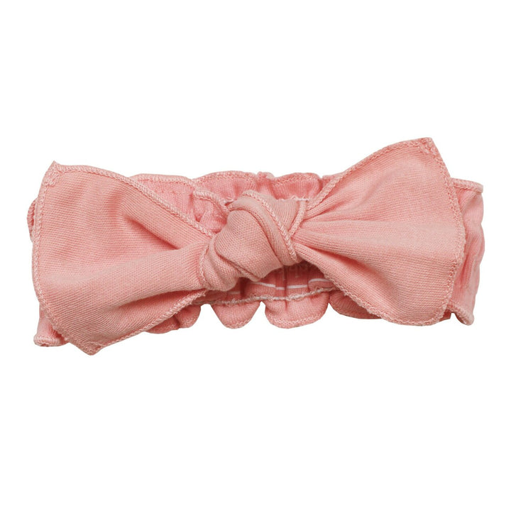 Organic Smocked Tie Headband in Coral, a salmon pink color.