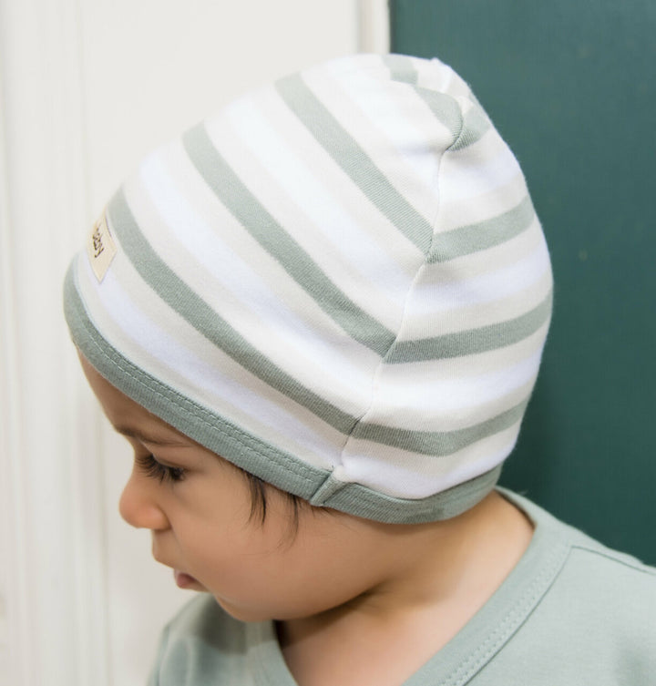 Child wearing Organic Cute Cap in Seafoam Stripe.