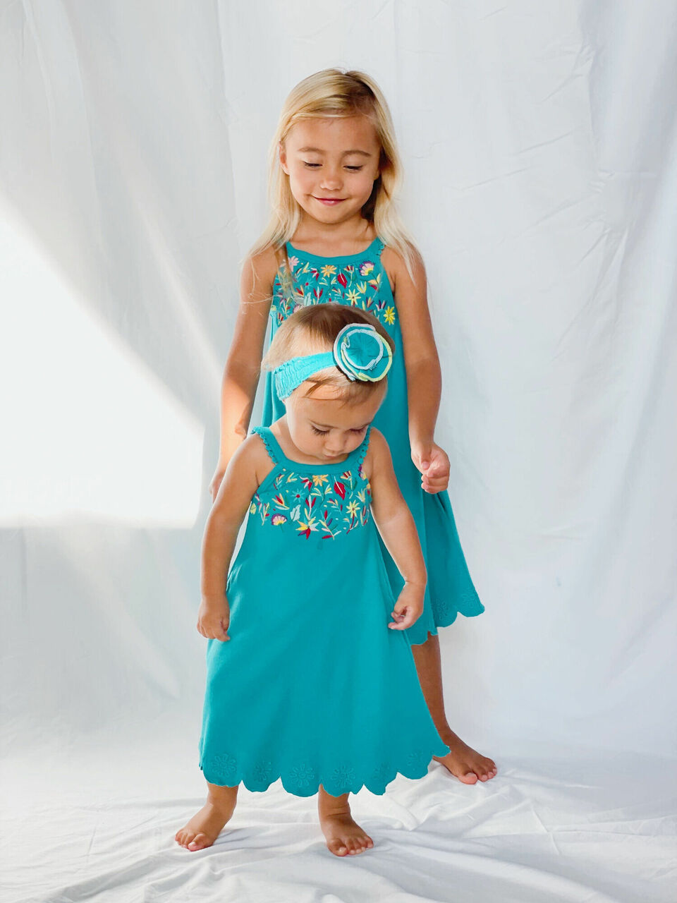 Child wearing Embroidered Twirl Dress w/Pockets in Teal Floral.