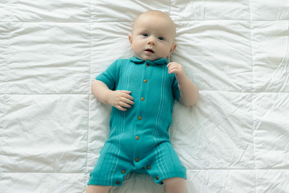 Child wearing Embroidered S/Sleeve Romper in Teal Dash.