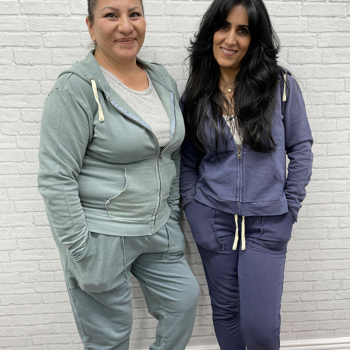2 women, one wearing Women's French Terry Jogger Pants in Jade, and 1 wearing same set in Indigo color.