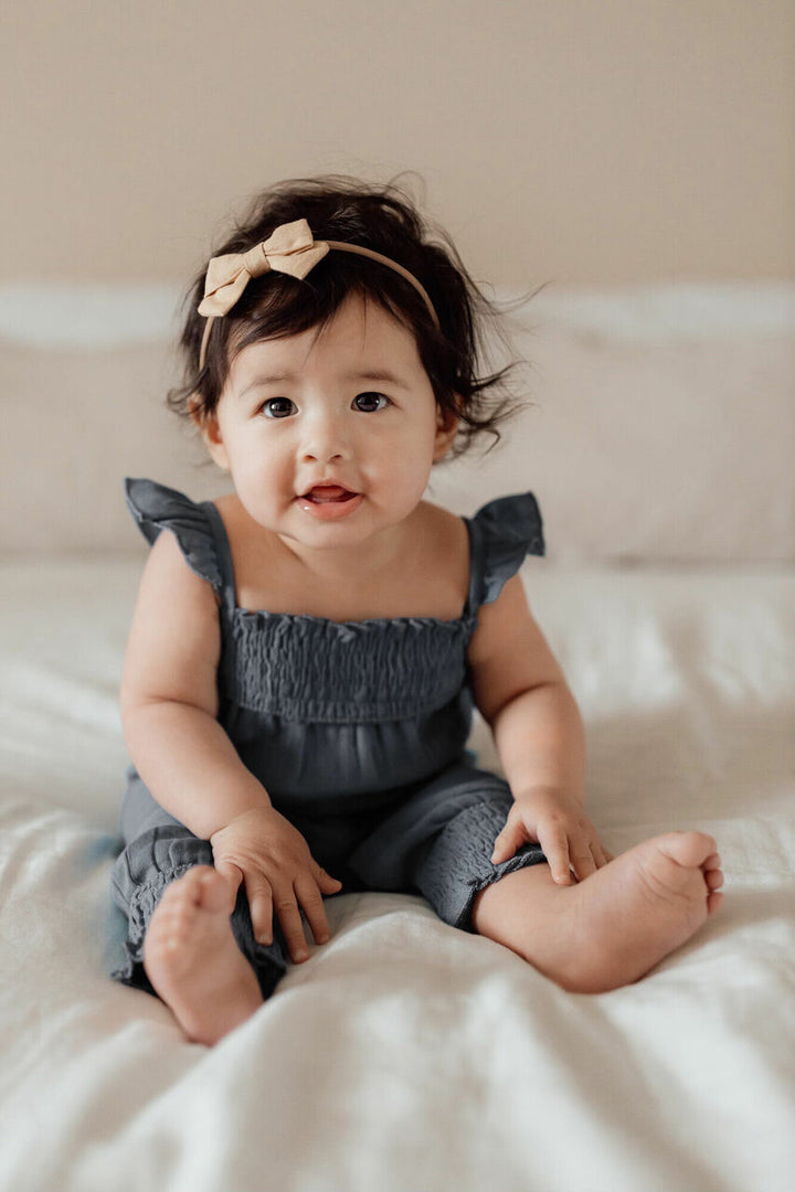 Child wearing Muslin Sleeveless Romper in Moonstone.
