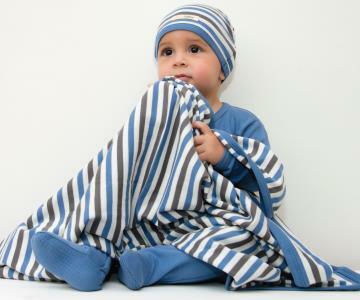 Child wearing Organic Swaddling Blanket in Slate Stripe.