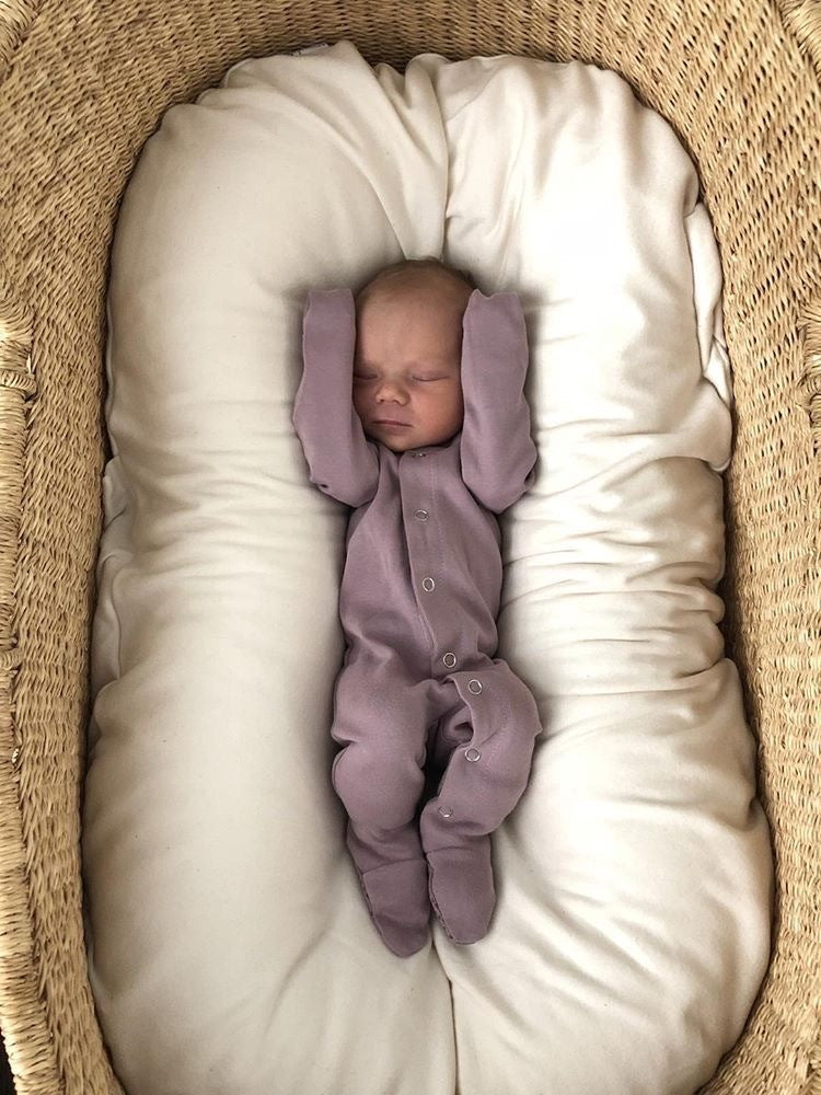 Child wearing Organic Snap Footie in Lavender.