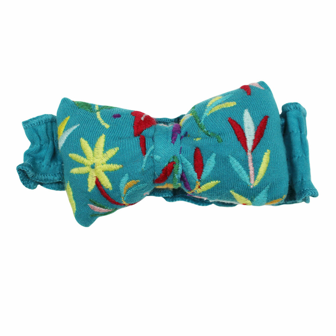 Embroidered Bowtie Headband in Teal Floral, a greenish blue base fabric with multi colored embroiderred flowers.