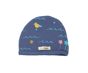 Organic Cute Cap in Slate Surf, a medium blue fabric with surfing prints.