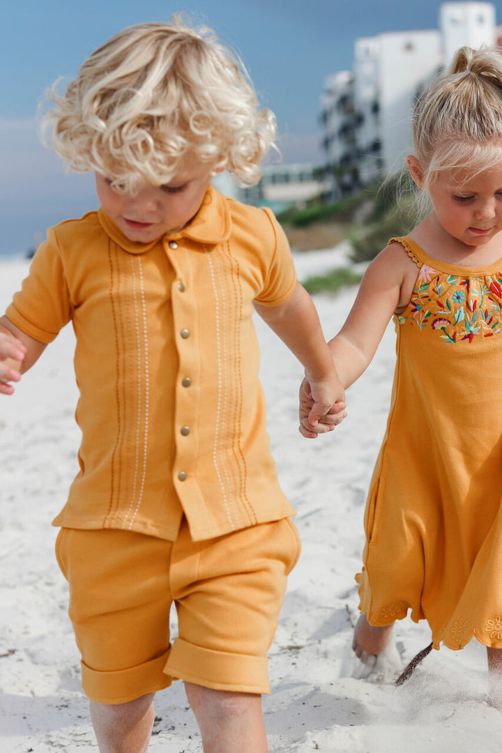 Child wearing Kids' Embroidered Shirt & Shorts Set in Tangerine Dash.