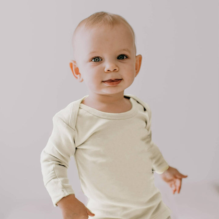 Child wearing Organic L/Sleeve Shirt in Buttercream.