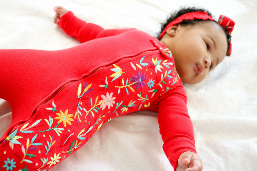 Child wearing Embroidered Zipper Footie in Chili Pepper Floral.