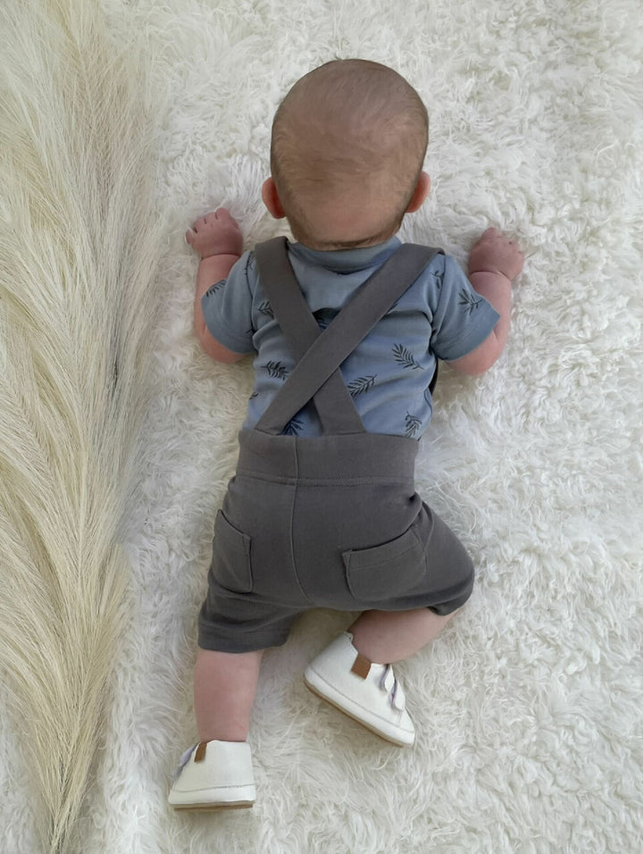Child wearing Suspender Shorts in Gray.