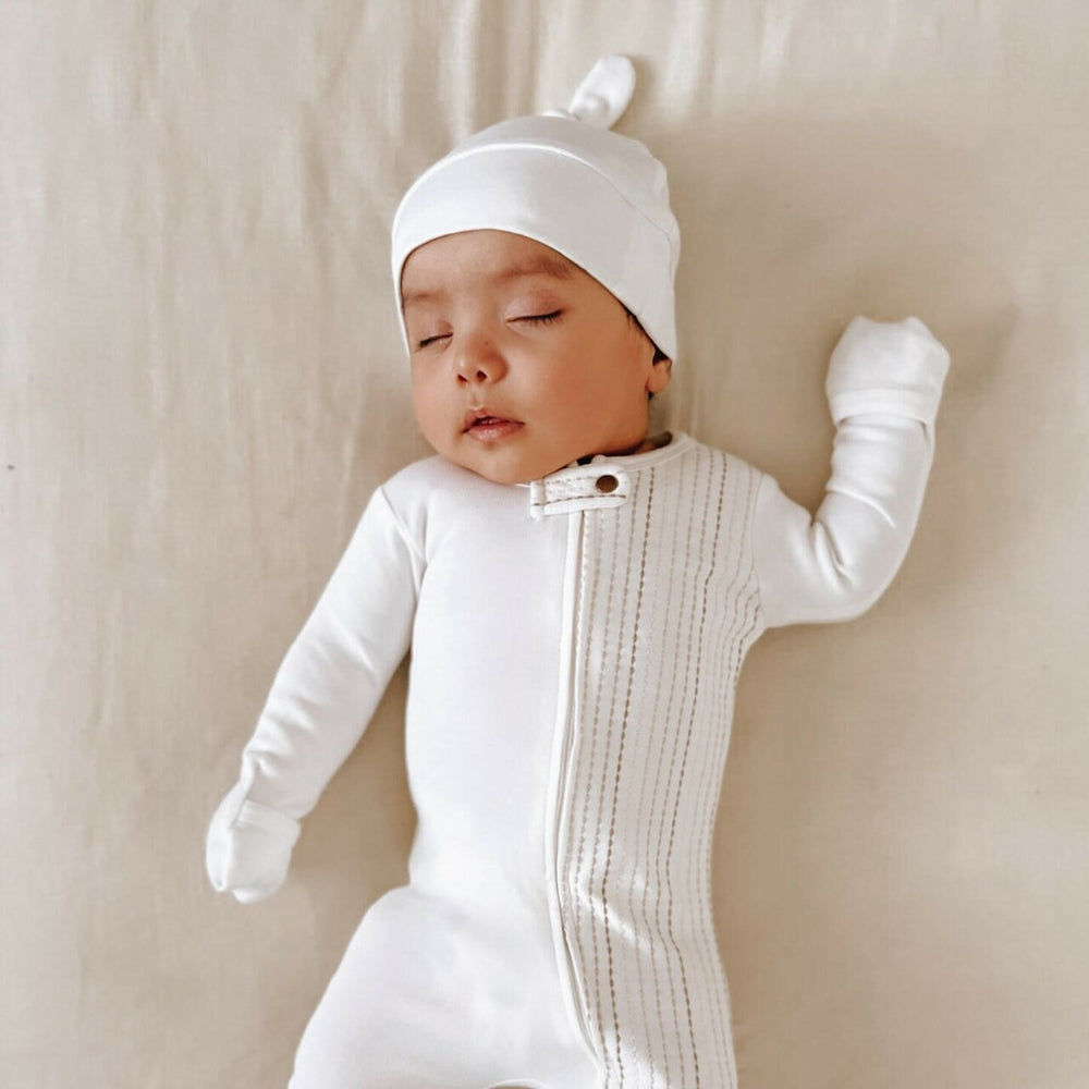 Child wearing Organic Banded Top-Knot Hat in White.