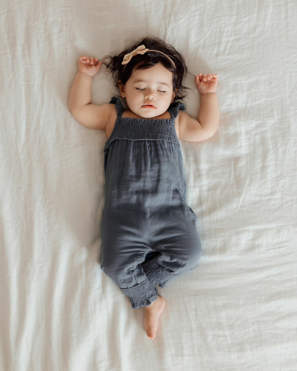 Child wearing Muslin Sleeveless Romper in Moonstone.