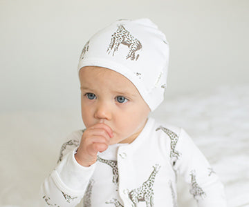 Child wearing Organic Cute Cap in White Giraffe.