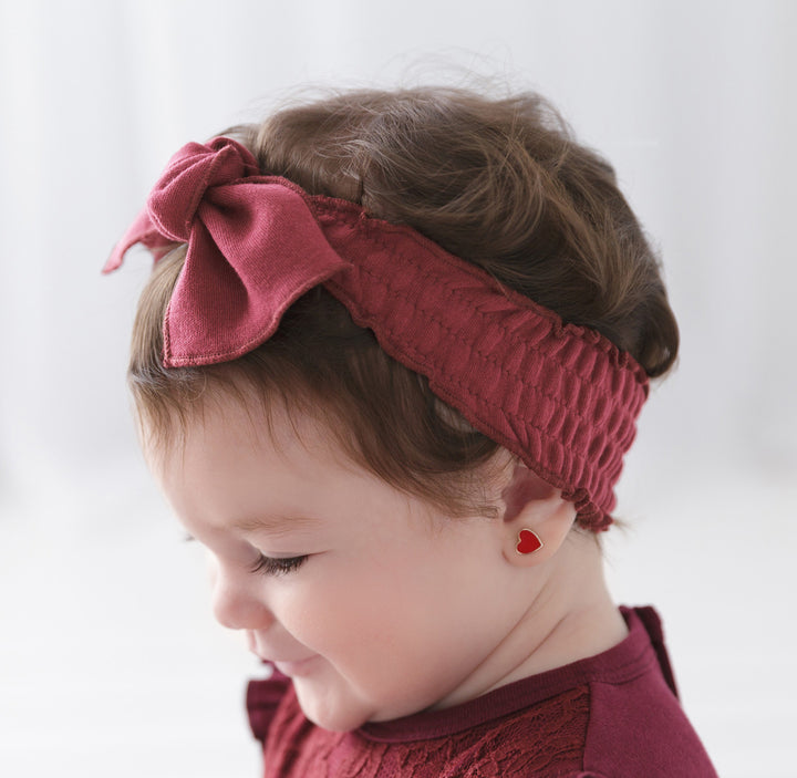 Child wearing Organic Smocked Tie Headband in Appleberry.