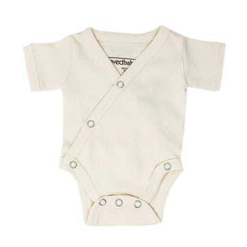 Organic Short-Sleeve Kimono Bodysuit in Buttercream, a light beige color.