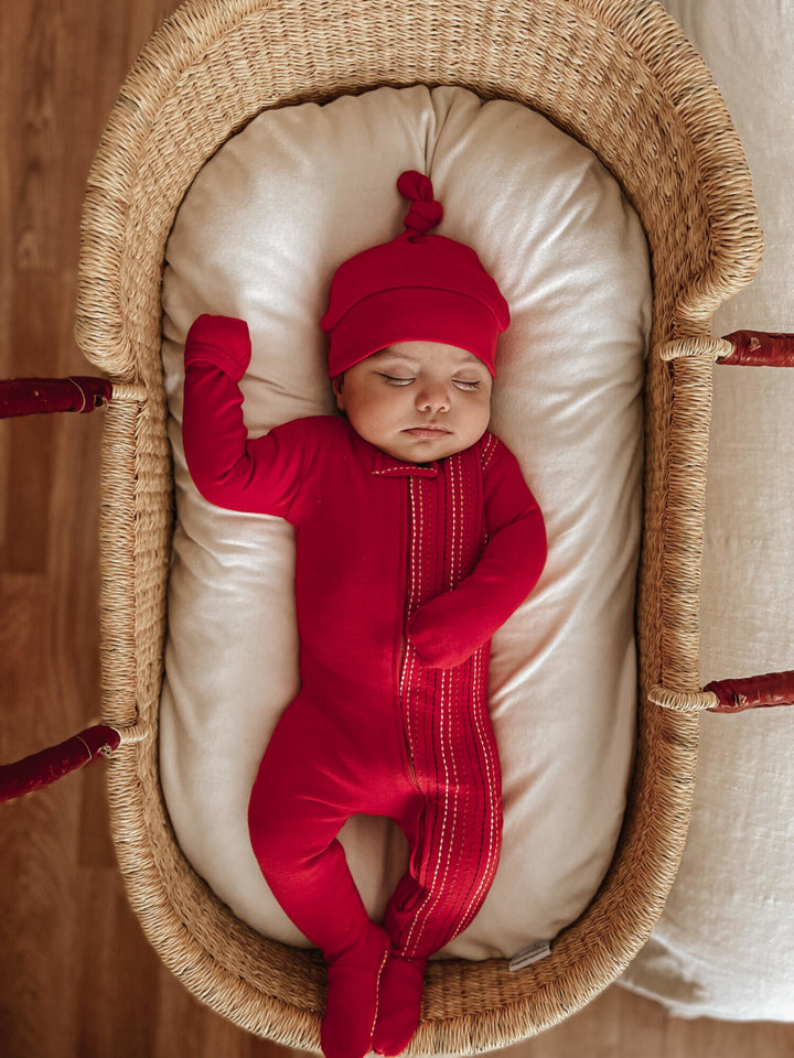 Child wearing Embroidered Zipper Footie in Chili Pepper Dash.